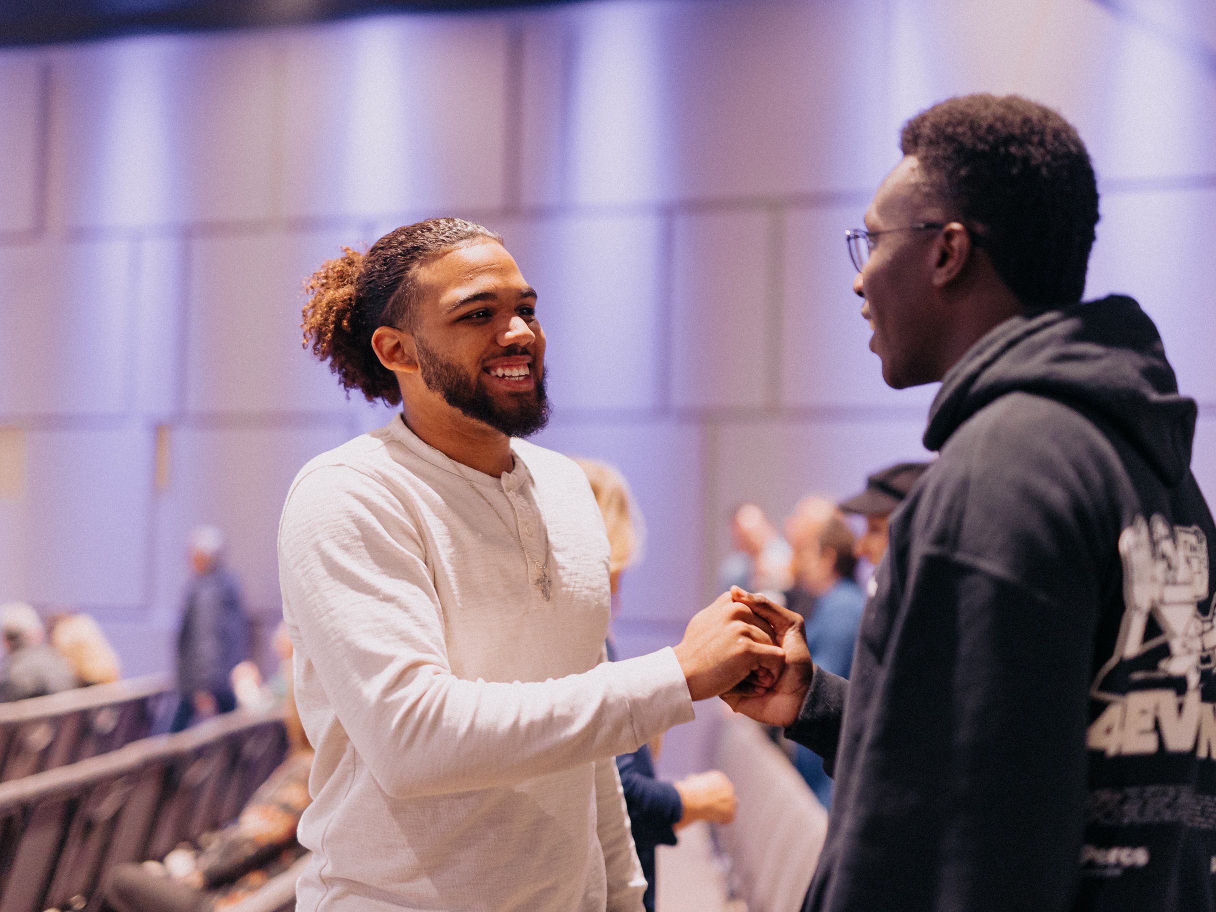 Two men shaking hands and smiling