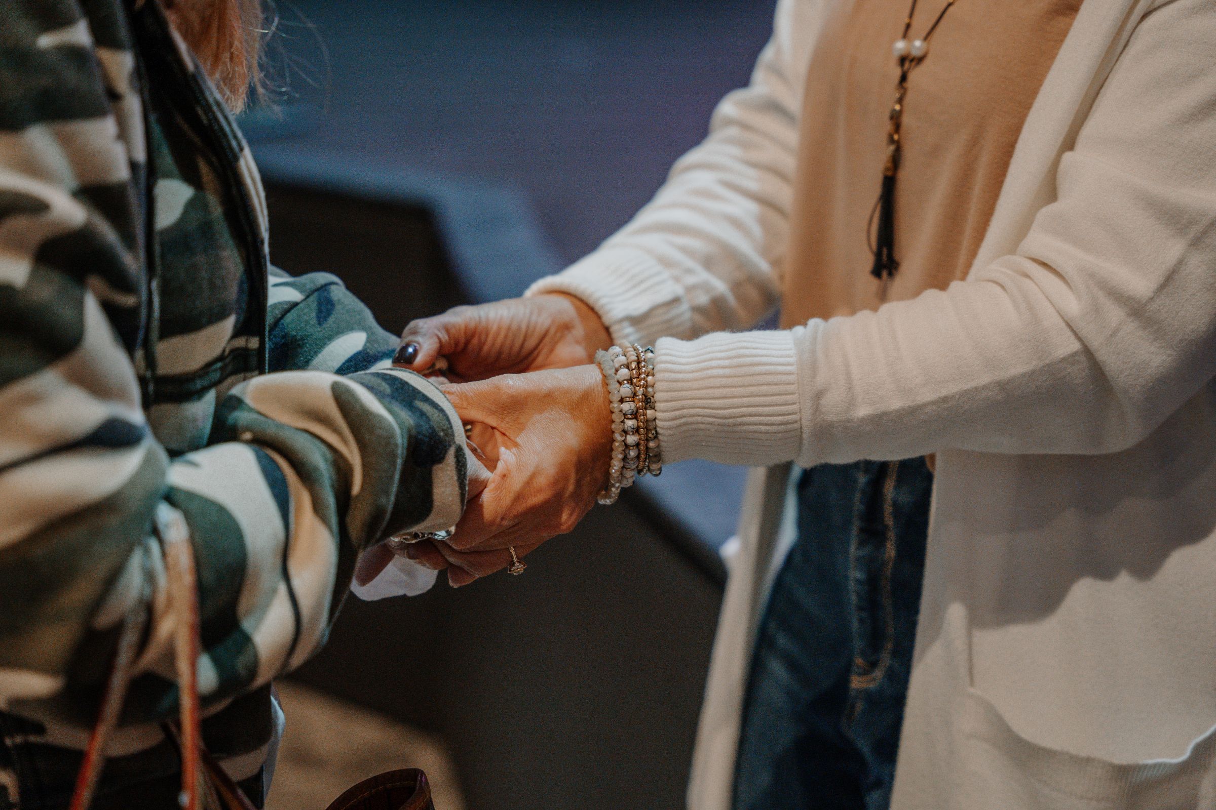 Woman holding another womans hands