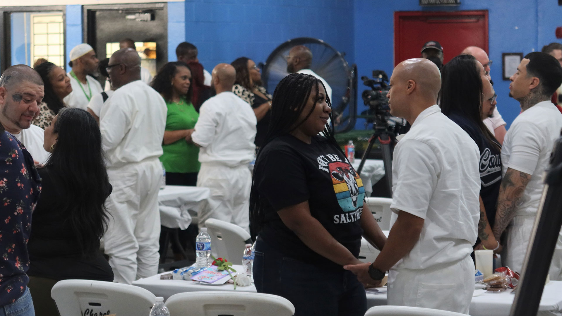 Inmates holding hands with their spouse